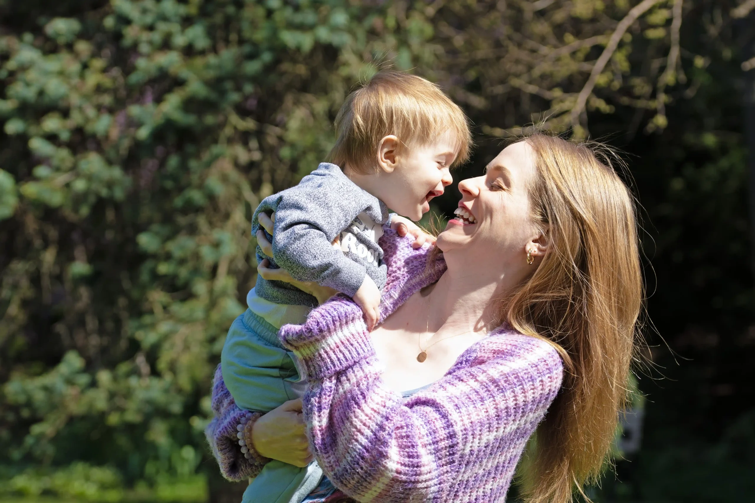 Child and mother. Then mother is holding the child and both smile